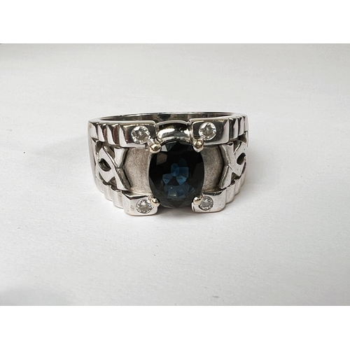 710 - A gent's dress ring with wide white metal shank set with central oval sapphire with small diamond to... 