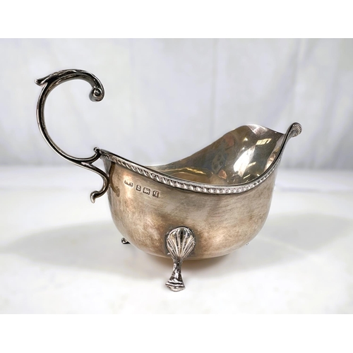 776 - A hallmarked silver sauce boat with 'C' scroll handle and 3 hoof feet, Birmingham 1911, 4oz