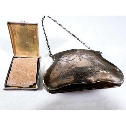 778 - A hallmarked silver purse with chased ribbon and swag decoration, marks worn; an engine turned compa... 