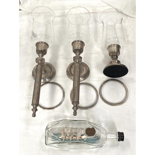 79 - Two silvered metal candle wall lights with waisted glass shade; a similar table lamp; a vintage ship... 