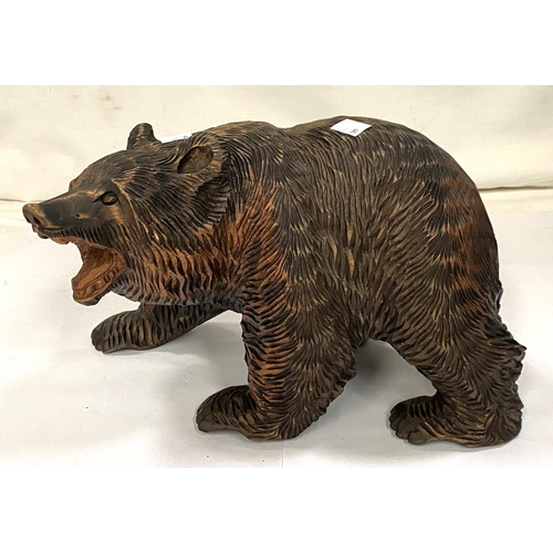 82A - A Black Forest carved bear, length 28cm