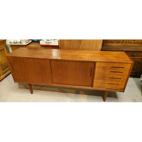 943 - A 1960's G-Plan style teak sideboard with 2 sliding doors and 4 drawers