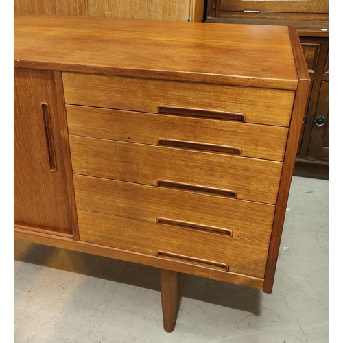 943 - A 1960's G-Plan style teak sideboard with 2 sliding doors and 4 drawers