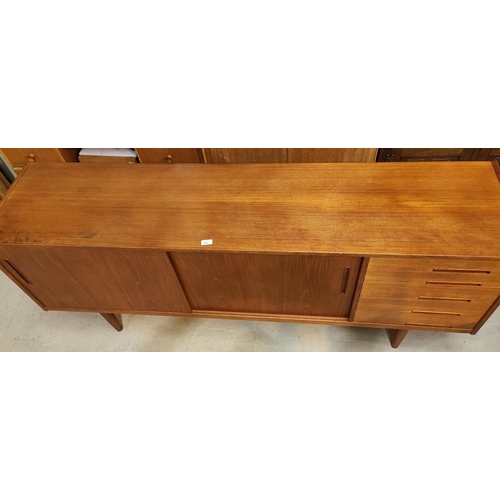 943 - A 1960's G-Plan style teak sideboard with 2 sliding doors and 4 drawers