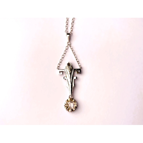 757 - An Art Deco cruciform style white metal pendant with diamond drop, tests as 9ct, on fine chain stamp... 