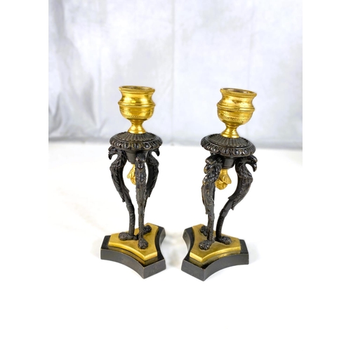 122 - A pair of 19th century gilt and bronze candle sticks on three bird shaped supports