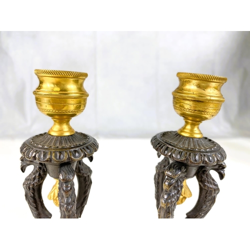 122 - A pair of 19th century gilt and bronze candle sticks on three bird shaped supports