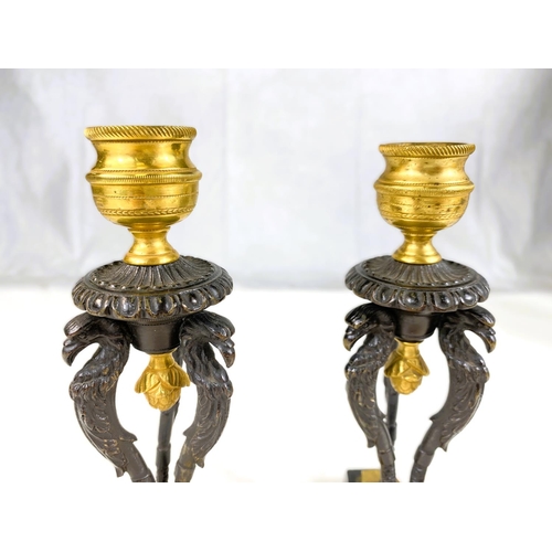 122 - A pair of 19th century gilt and bronze candle sticks on three bird shaped supports