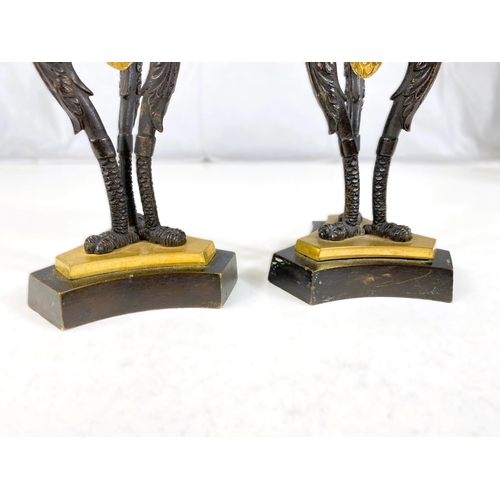 122 - A pair of 19th century gilt and bronze candle sticks on three bird shaped supports