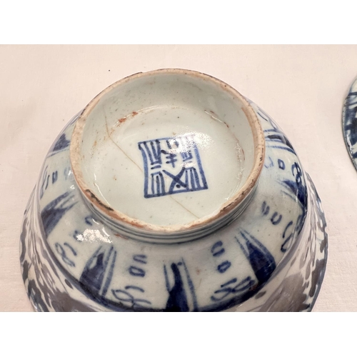 400 - Two Chinese bowls blue and white decoration with seal marks to base (chips to rim)