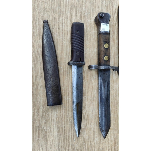 306 - A late 19th / early 20th century field bayonet knife, broad arrow marks and a similar German bayonet... 