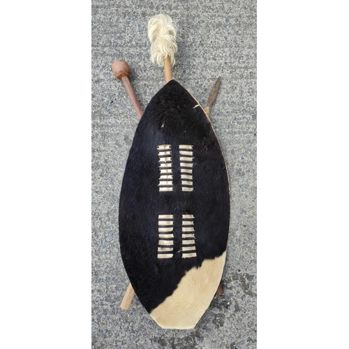 309C - A 20th century tribal wall hanging comprising hide shield, spear and club