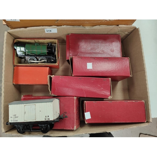 319 - An originally boxed Hornby 0 gauge tin plate clockwork locomotive and tender; 5 boxed 0 gauge carria... 