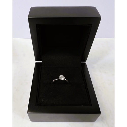 763 - An 18ct hallmarked white gold lady's solitaire diamond ring, size H/I, in double presentation box wi... 