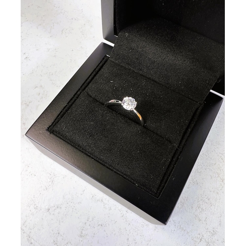 763 - An 18ct hallmarked white gold lady's solitaire diamond ring, size H/I, in double presentation box wi... 