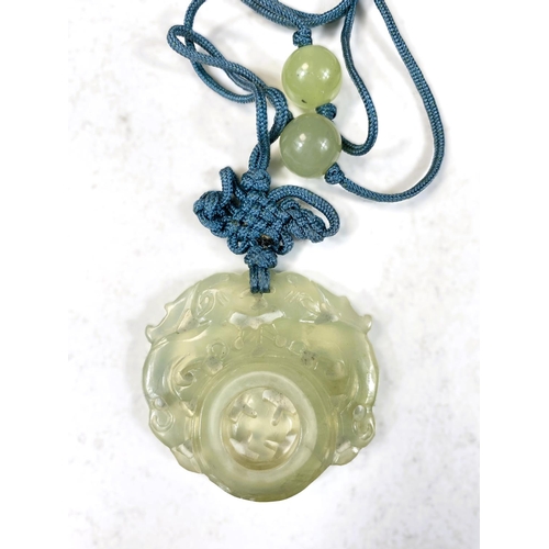 709 - A New Zeland Tiki nephrite jade pendant with carved face and a Chinese jade pendant 