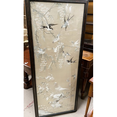 409 - A large Chinese embroidered picture depicting birds in branches, 137 x 51cm framed and glazed