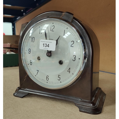 134 - A mid 20th century bakelite cased mantle clock with silvered dial and striking movement by Enfield, ... 