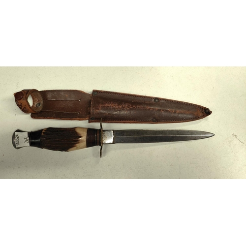 265 - An Early 20th century Fairbairn style fighting knife with horn handle and leather sheath