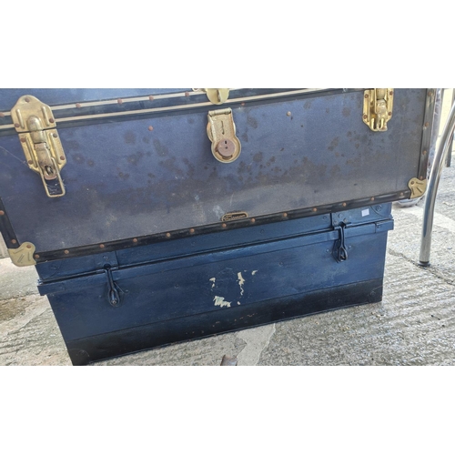 995 - A blue cabin trunk and a metal cabin trunk