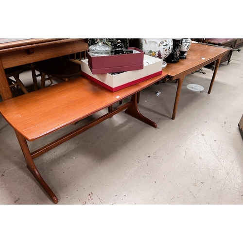 957 - A 1960's rectangular teak coffee table with leaves to each end; a similar table