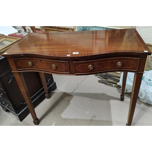 930 - A reproduction mahogany serpentine front side table with two frieze drawers and cross banded burr wa... 