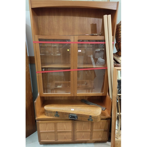 975 - A Nathan teak bookcase with central glazed shelves, open shelf above and typical double cross panel ... 