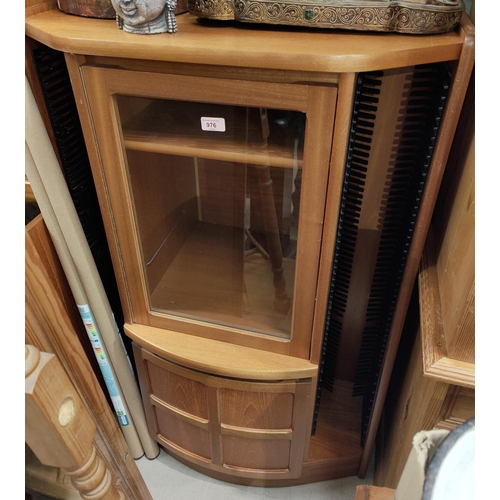 976 - A Nathan teak cupboard with glazed cupboard over second cupboard with typical cross panel door, flan... 