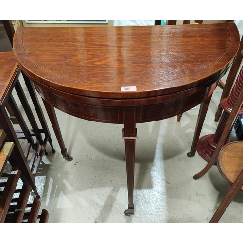 988 - A Sheraton style demi-lune inlaid mahogany card table with baize lined interior, square top, legs an... 