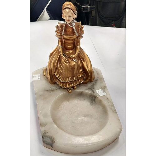 135 - A 1920's polished marble dish with applied figure of a girl in Regency dress, 18cm