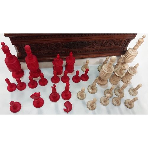 150 - A vintage red and white stained bone chess set with a carved wood box (ht. of King 10.5cm) (hairline... 