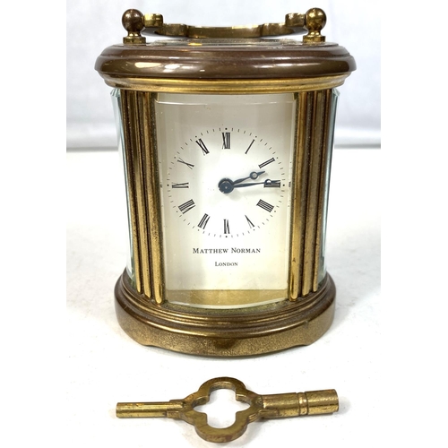 27 - A small oval brass carriage clock by Matthew Norman, ht 8cm, a Zeiss Ikon camera