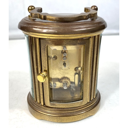 27 - A small oval brass carriage clock by Matthew Norman, ht 8cm, a Zeiss Ikon camera