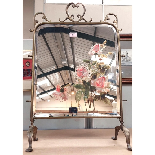 34 - An Edwardian brass framed mirror fire screen with hinged side panels, 72cm high, a framed crystoleum... 