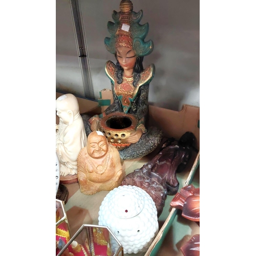 52 - An incense burner in the form of a seated Buddha and other busts and facemasks 