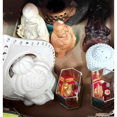 52 - An incense burner in the form of a seated Buddha and other busts and facemasks 