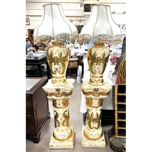 64 - A pair of classical columns in cream and gilt and matching table lamps