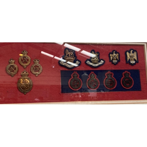 70 - A framed and glazed collection of military badges and a watercolour of modern military ships