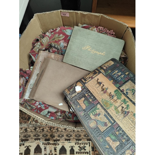 204 - A small hand knotted Persian rug, table coverings + linen; several photo albums.