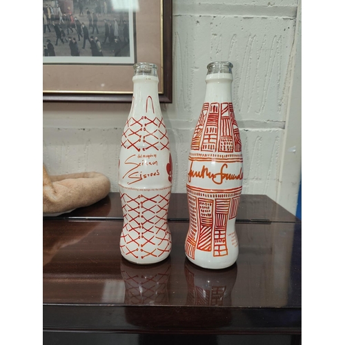 209B - A vintage Coca-Cola poster, two bottles with decoration by the Scissor Sisters and another and a Lin... 