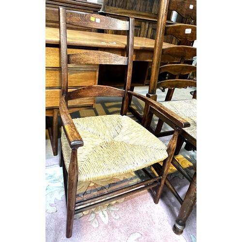 932 - A set of four good quality oak dining chairs with rush seats, turned legs etc and another similar ch... 