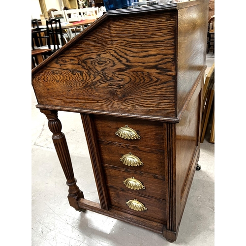 937 - A late 19th Century oak Davenport desk with inset green leather scriber, with four side drawers and ... 