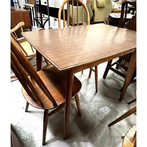 943 - A set of 4 elm and beech hoop and stick back dining chairs and a rectangular wood effect kitchen tab... 