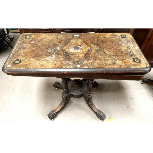 947 - A 19th century inlaid folding table with four pillar support (centre damaged)