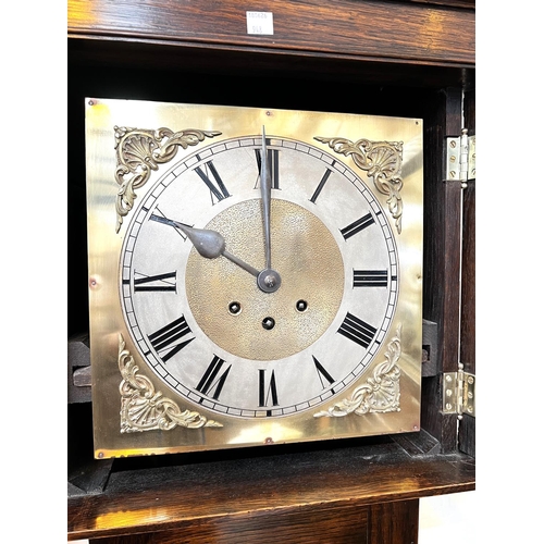 948 - An early 20th century oak longcase clock with barley twist columns to the hood, with square brass di... 