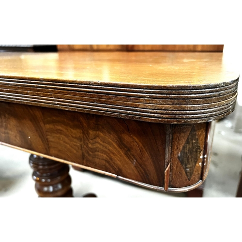 956 - A 19th Century mahogany fold over tea table on turned and ringed column, four splay feet and brass c... 