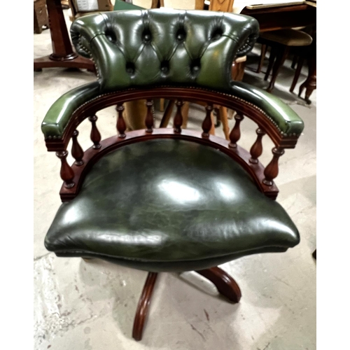 967 - A Captains style swivel armchair in buttoned green hide