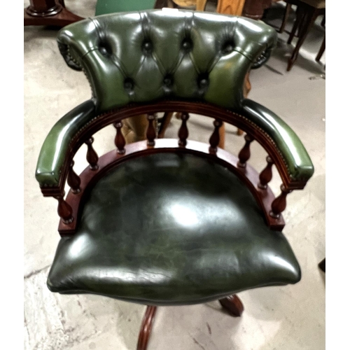 967 - A Captains style swivel armchair in buttoned green hide