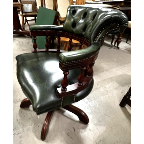 967 - A Captains style swivel armchair in buttoned green hide