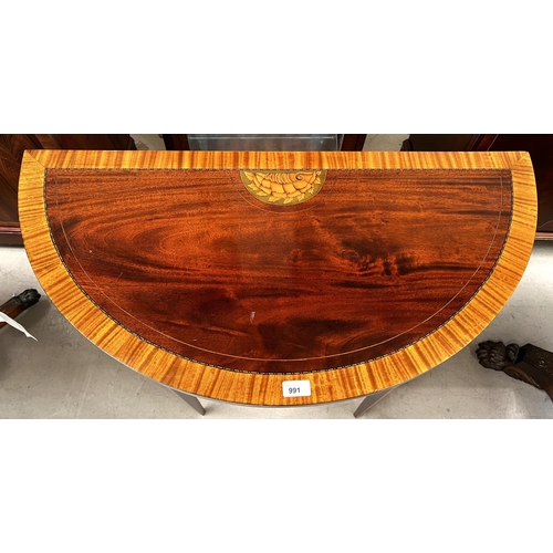 991 - A Sheraton style demi-lune inlaid mahogany card table with wide satinwood crossbanding and shell inl... 